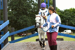 White pony and rider being lead - competition