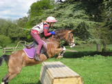 Pony and rider cross country jumping